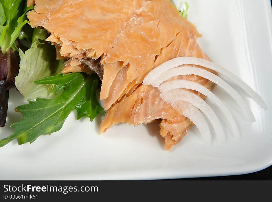 Alaskan smoked sockeye salmon starter on a bed of lettuce