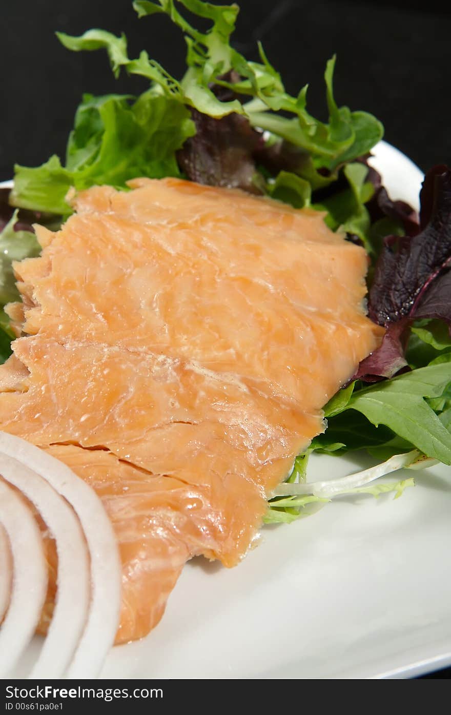 Alaskan smoked sockeye salmon starter on a bed of lettuce