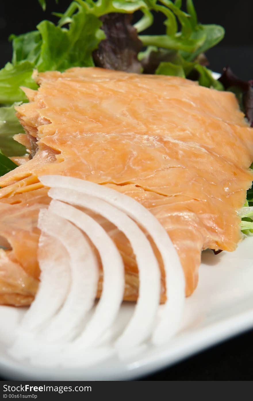 Alaskan smoked sockeye salmon starter on a bed of lettuce