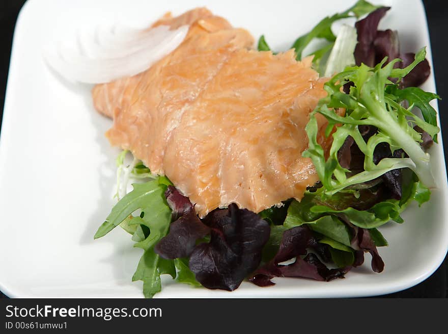 Alaskan smoked sockeye salmon starter on a bed of lettuce