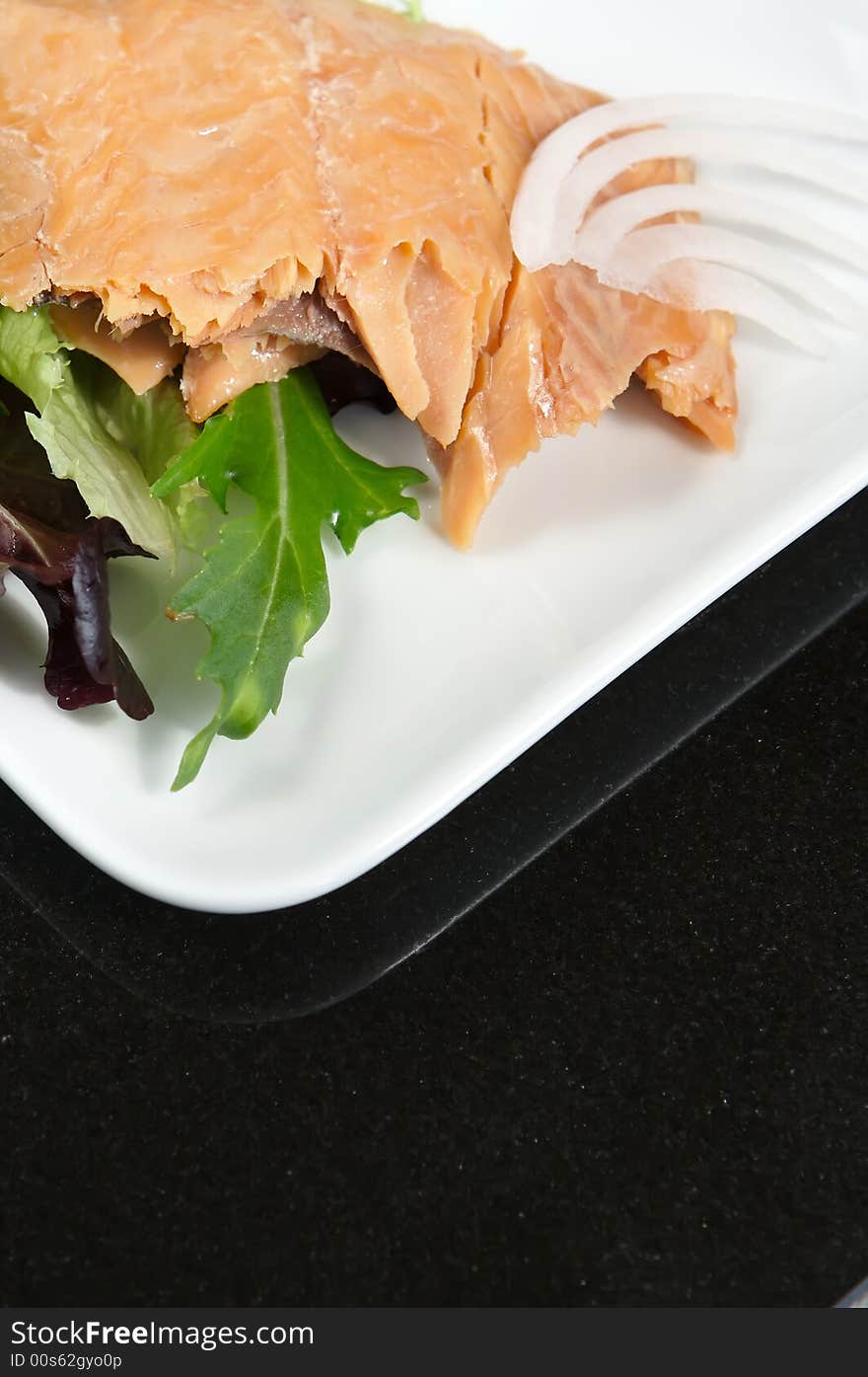 Alaskan smoked sockeye salmon starter on a bed of lettuce