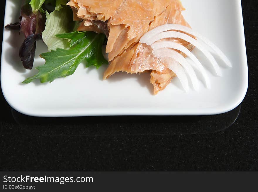 Alaskan smoked sockeye salmon starter on a bed of lettuce