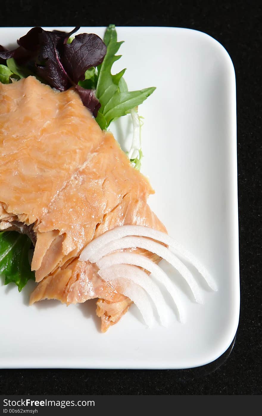 Alaskan smoked sockeye salmon starter on a bed of lettuce