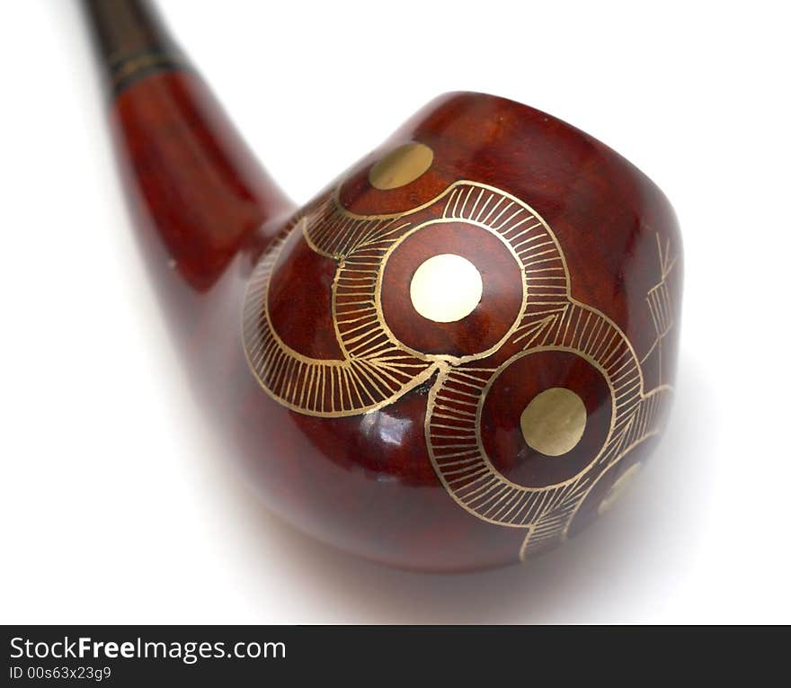 Close-up of curved ornamented north-caucasian pipe with white background