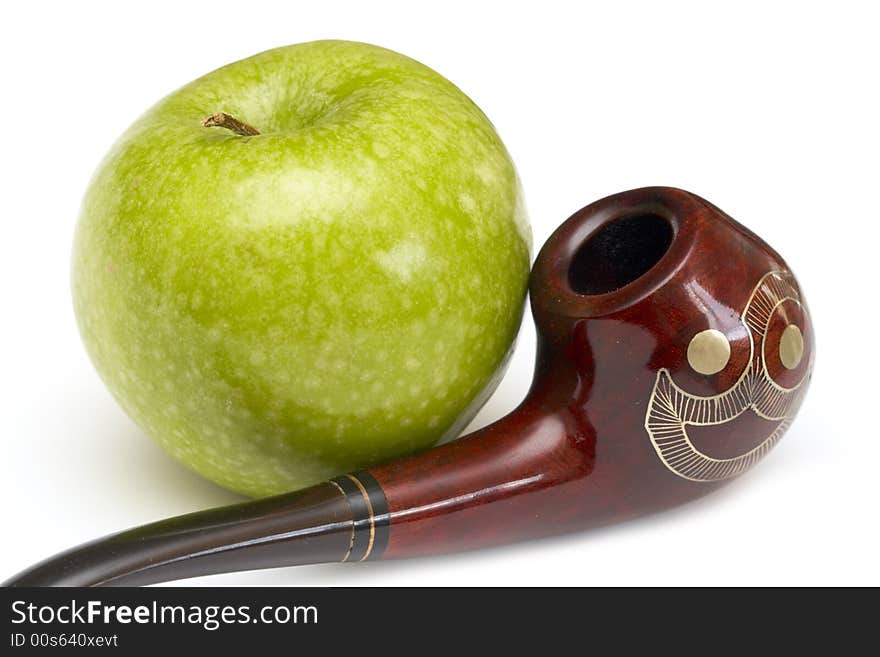 Long ornamented north-caucasian pipe with big green apple at white background. Long ornamented north-caucasian pipe with big green apple at white background