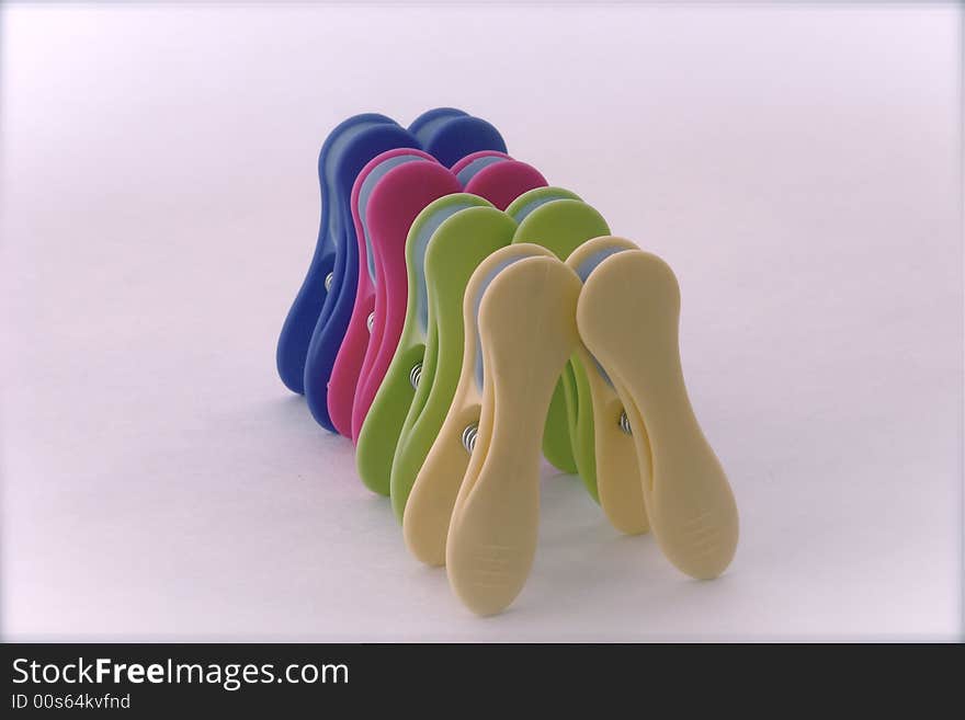 Group of clamps for hanging cloths symbolizing a queue of people