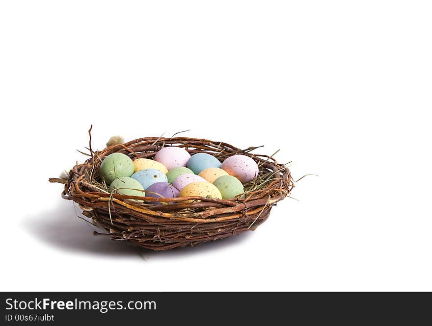 A bird nest with full of spotted eggs in it. Perfect for easter concept. Isolated on white. A bird nest with full of spotted eggs in it. Perfect for easter concept. Isolated on white