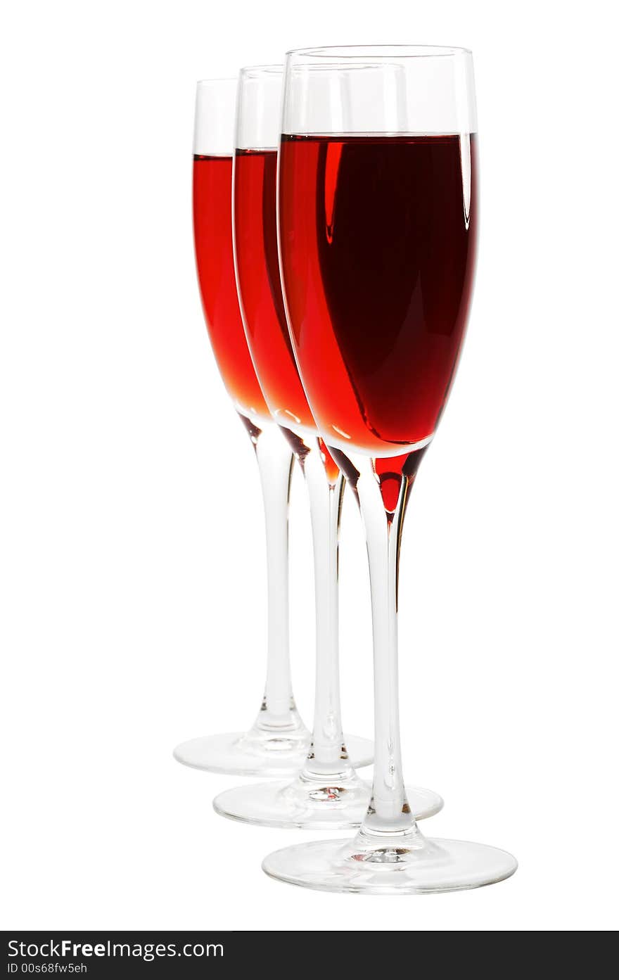 Three glasses with red wine on a white background