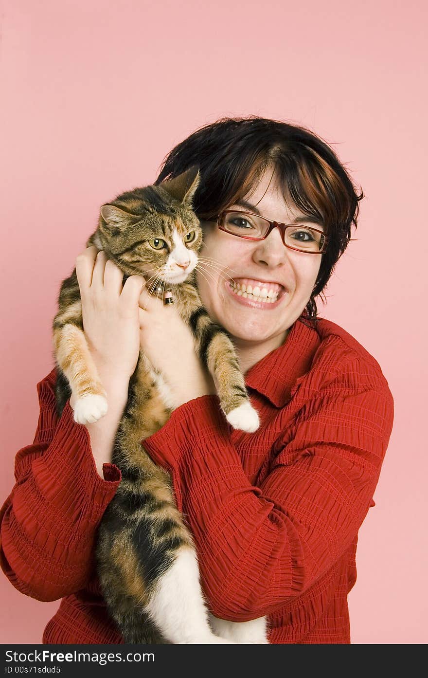 Young woman holds a domestic cat