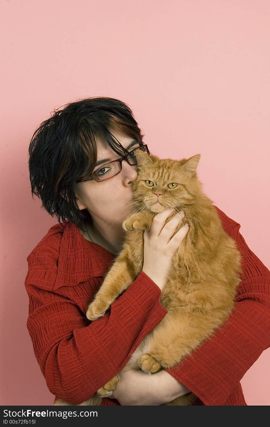 Beautiful woman holding a domestic red house cat