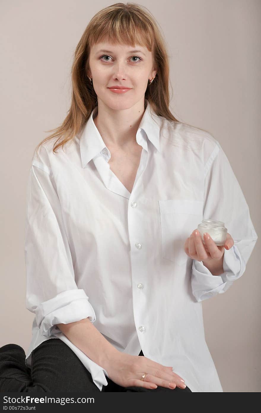 A girl in white shirt with cream for make-up