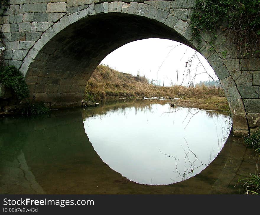 A popular and famous bridge stands in the valley in Guangxi Province in China. A popular and famous bridge stands in the valley in Guangxi Province in China.