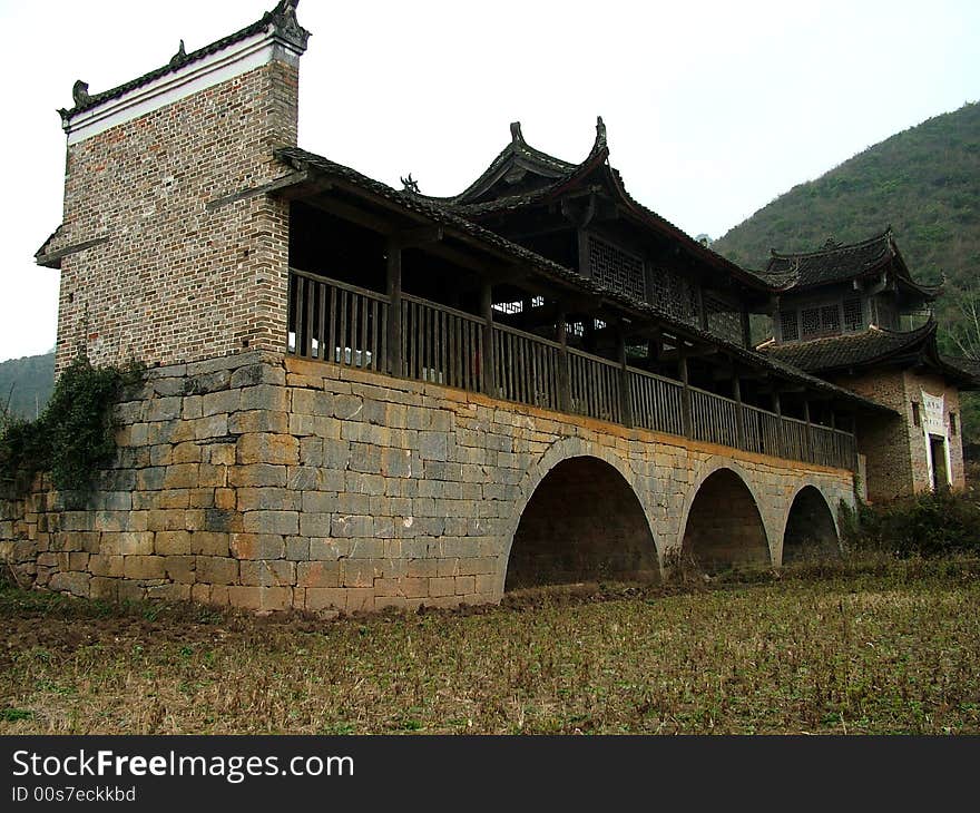 A popular and famous bridge stands in the valley in Guangxi Province in China. A popular and famous bridge stands in the valley in Guangxi Province in China.