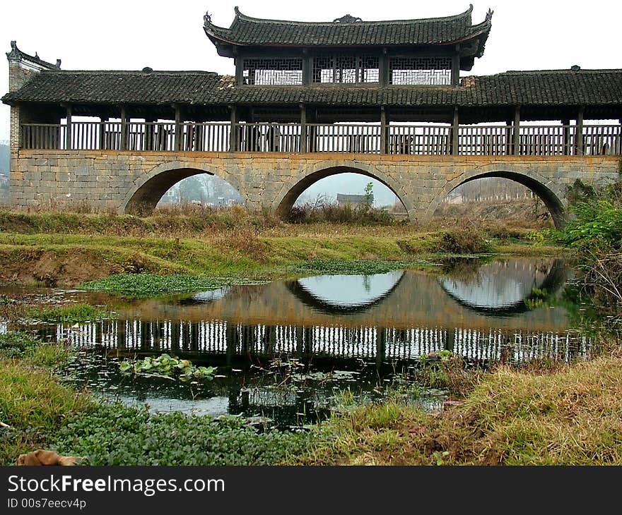 A popular and famous bridge stands in the valley in Guangxi Province in China. A popular and famous bridge stands in the valley in Guangxi Province in China.