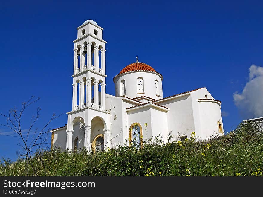 Orthodox cretan church with the  blue sky as background. Orthodox cretan church with the  blue sky as background