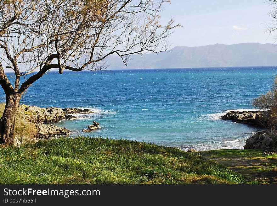 Blue water of the mediterranian sea and the rocky shore