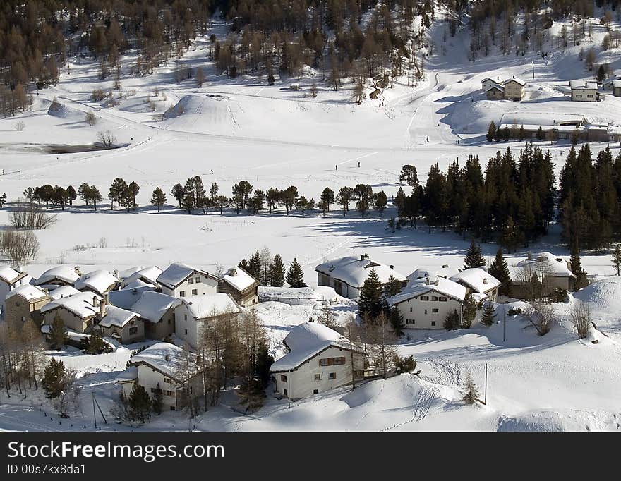 Snowy village in the Alps (switzerland - Maloja)