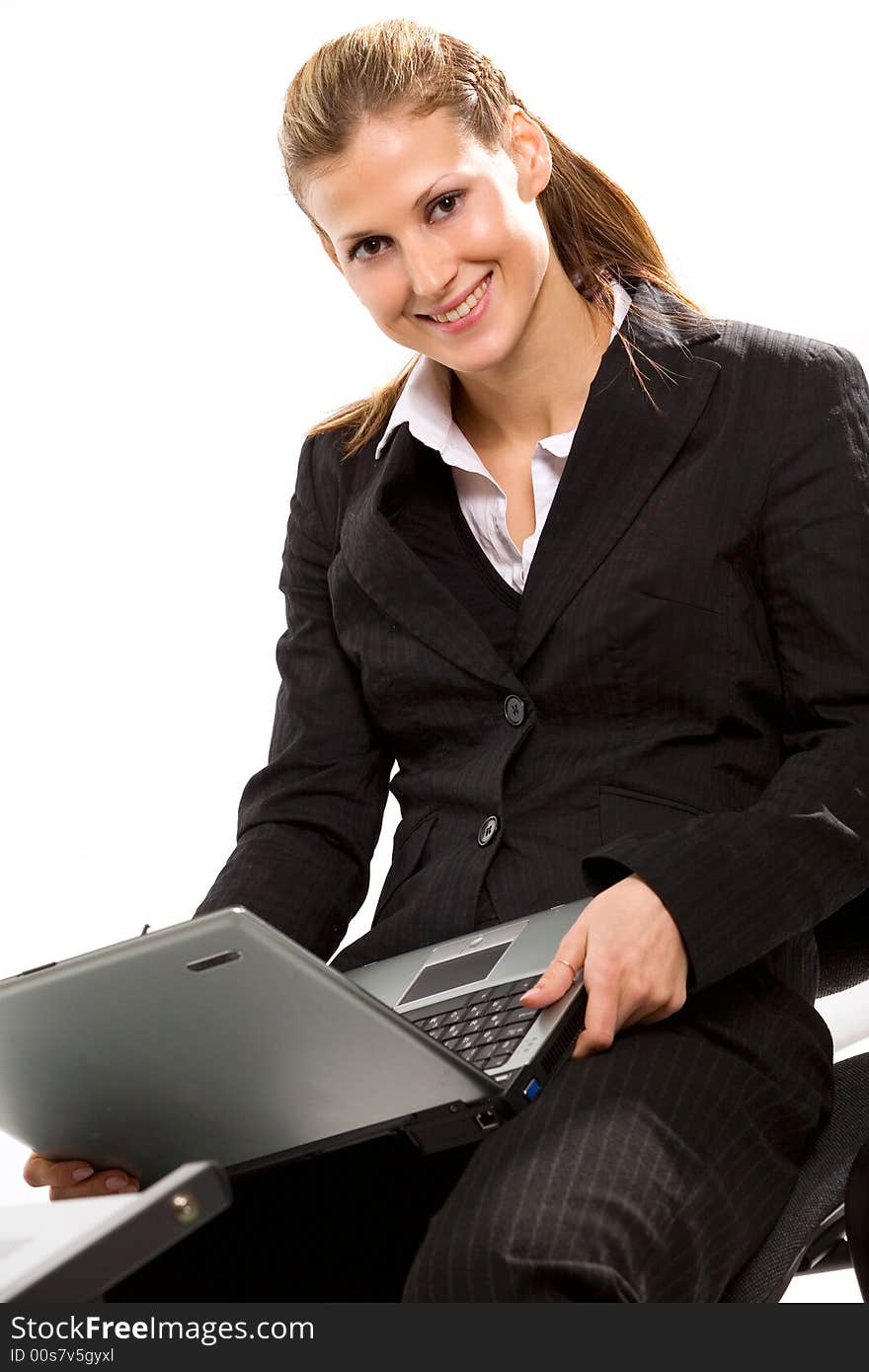 Pretty young businesswoman working with laptop