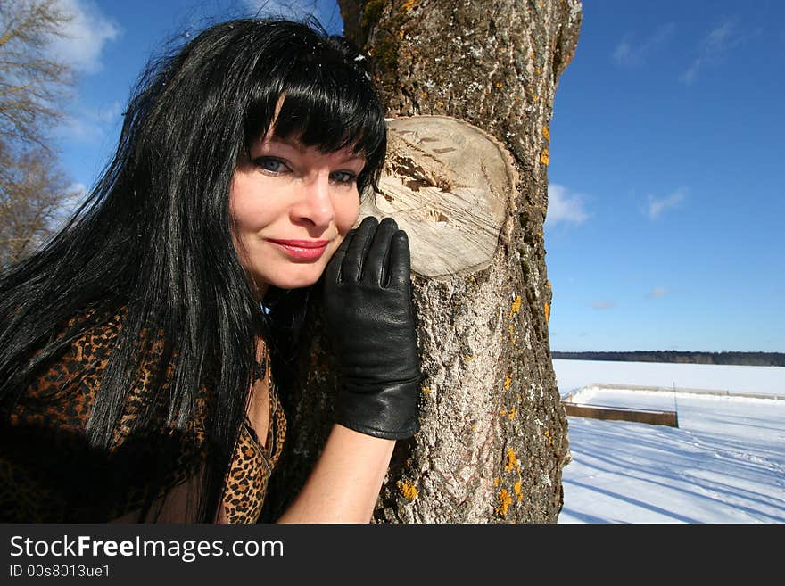 Woman near tree.