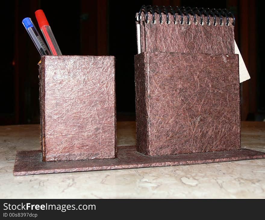 Notebook and pen holder made with recycled paper