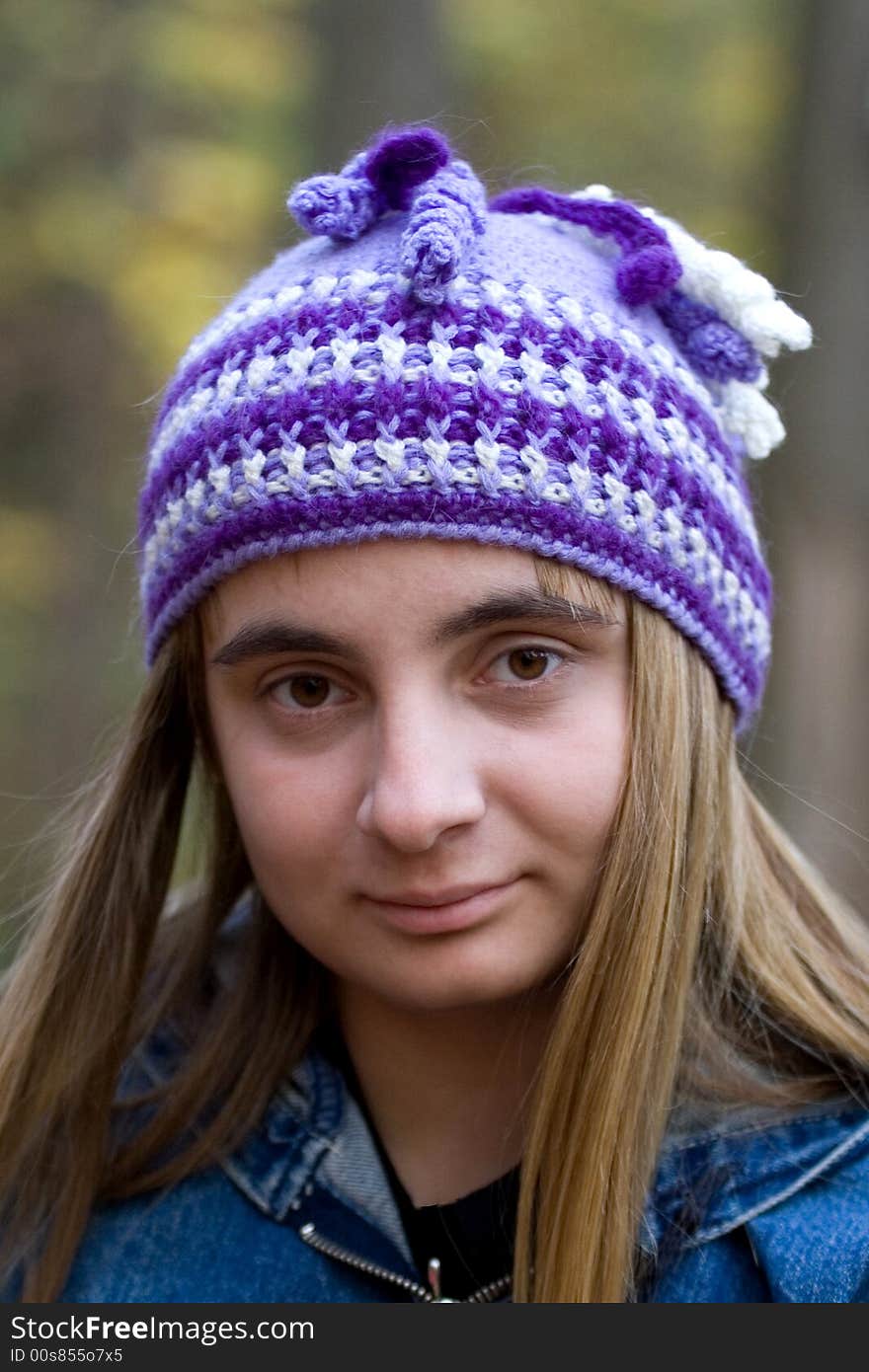 Portrait of the beautiful girl in autumn forest. It`s autumn. There is  cap on her head. Portrait of the beautiful girl in autumn forest. It`s autumn. There is  cap on her head