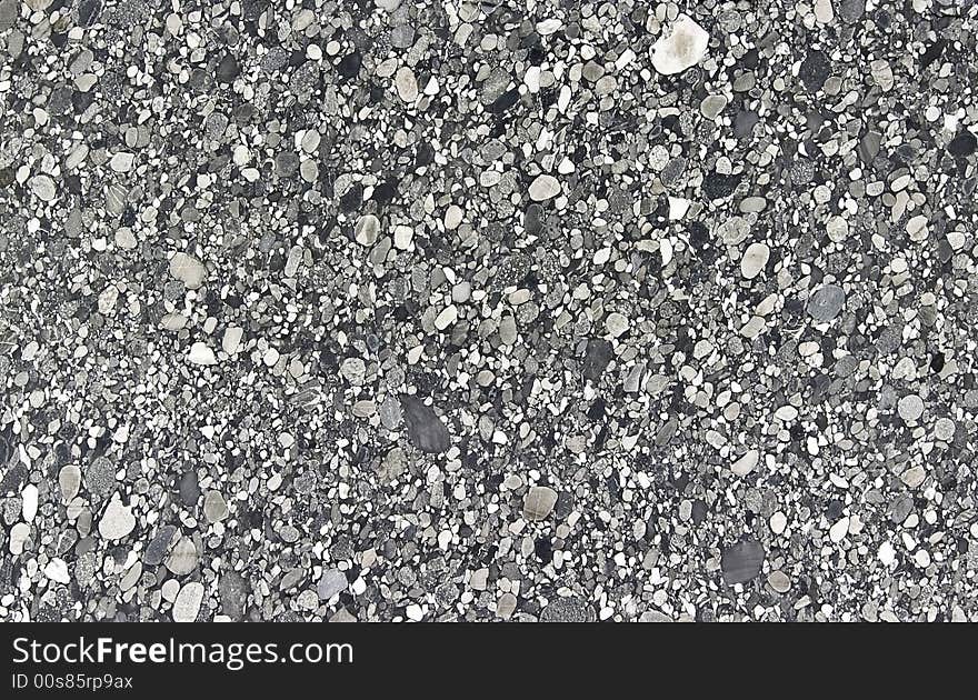 Grey granite surface for decorative works or texture. It is a granite or marble made of stones cutted and shiny.