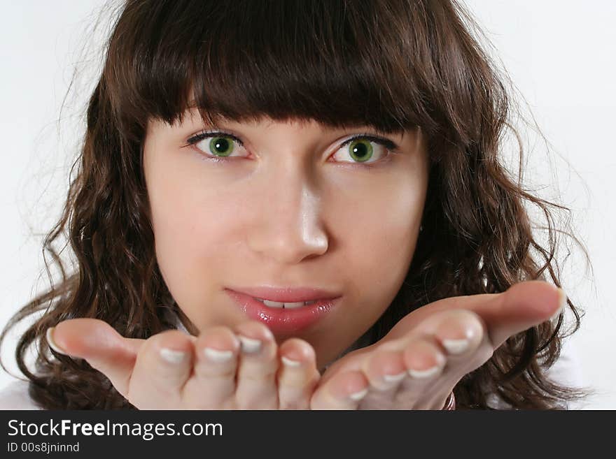 The green-eyed woman gives an air kiss