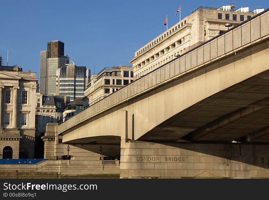 Modern buildings in and London bridge, view from water.  Horizontal. London, UK. Modern buildings in and London bridge, view from water.  Horizontal. London, UK.