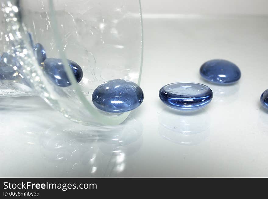 Round blue stones from a glass dish. Round blue stones from a glass dish