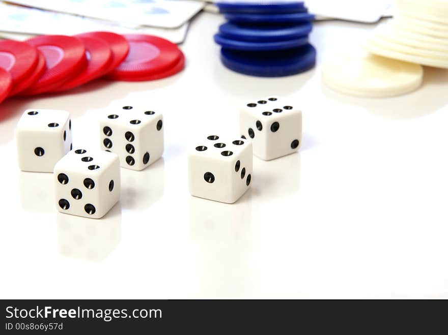 Multiple white dice with red and blue poker or game chips. Multiple white dice with red and blue poker or game chips