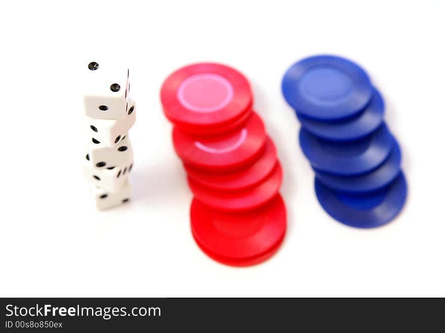 Multiple white dice with red and blue poker or game chips. Very low depth. Multiple white dice with red and blue poker or game chips. Very low depth.