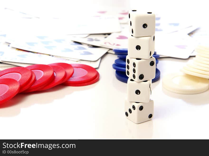 Multiple white dice with red and blue poker or game chips. Multiple white dice with red and blue poker or game chips