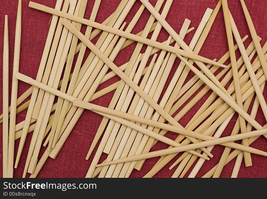 Chopsticks over red background