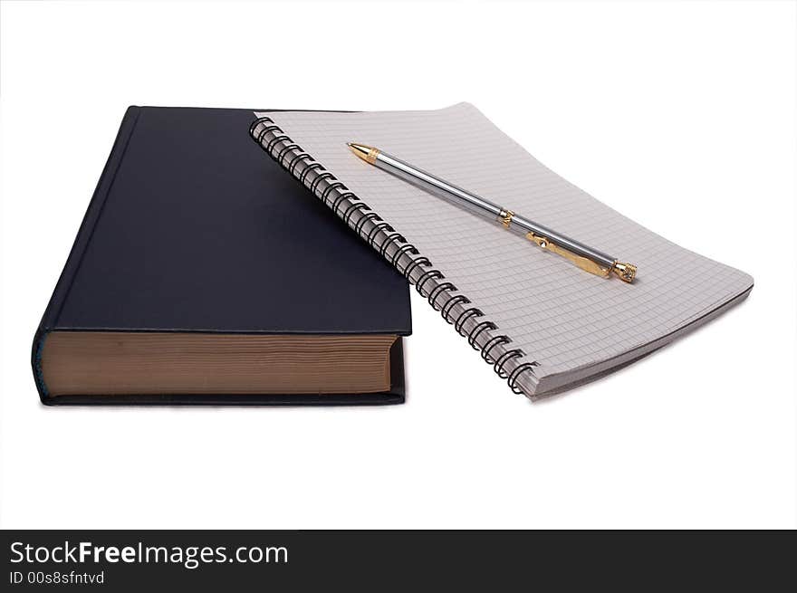 Pen on notebook and book on white