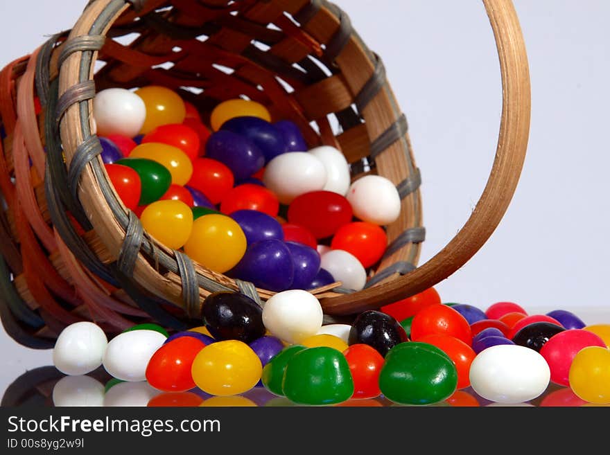 Jelly beans in a basket on light background. Jelly beans in a basket on light background