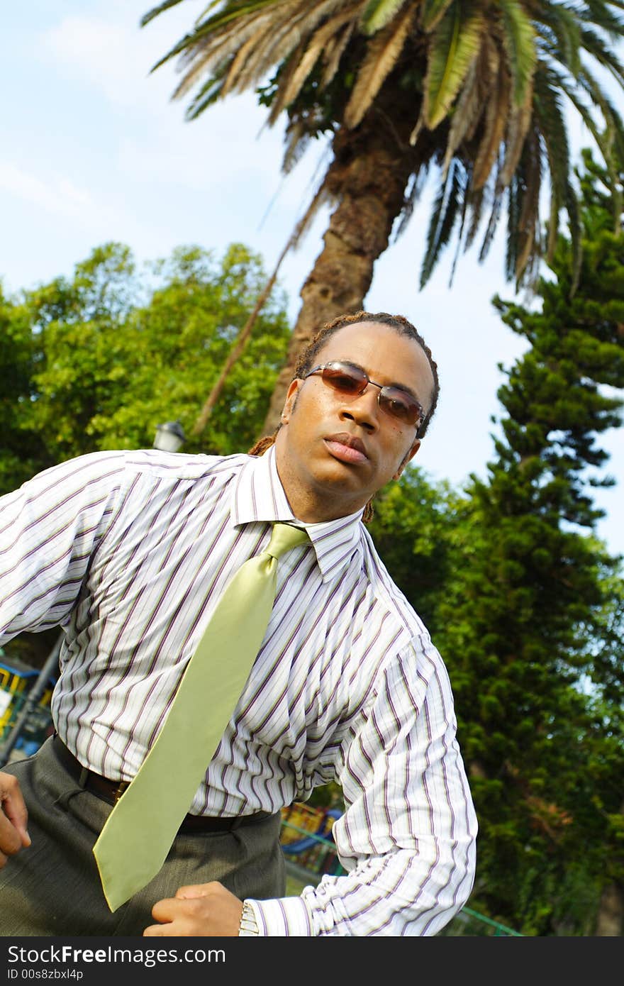 Businessman Flexing for the camera. Palm trees in the background. Businessman Flexing for the camera. Palm trees in the background.