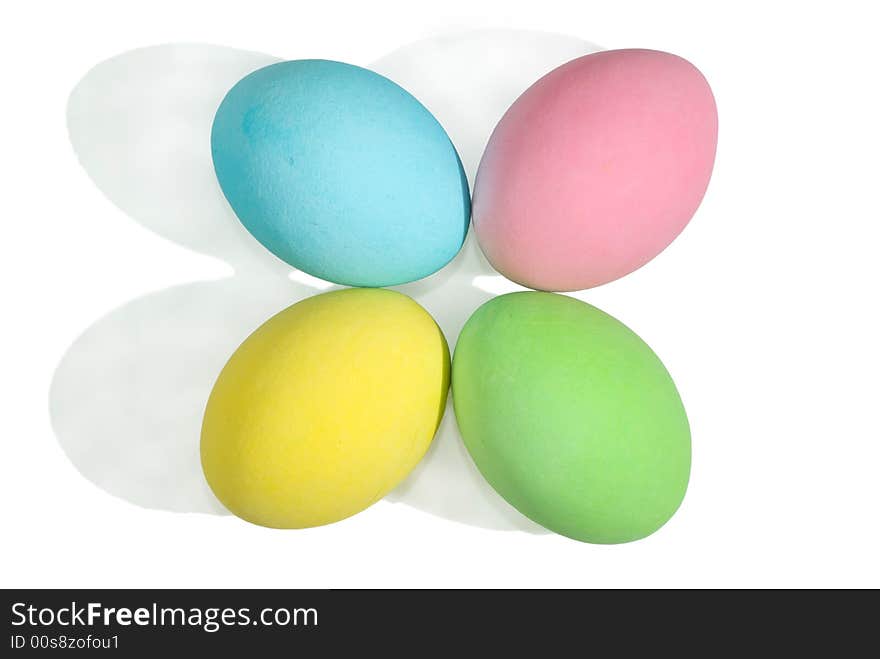 Closeup of a 4 colored easter eggs isolated in white background.