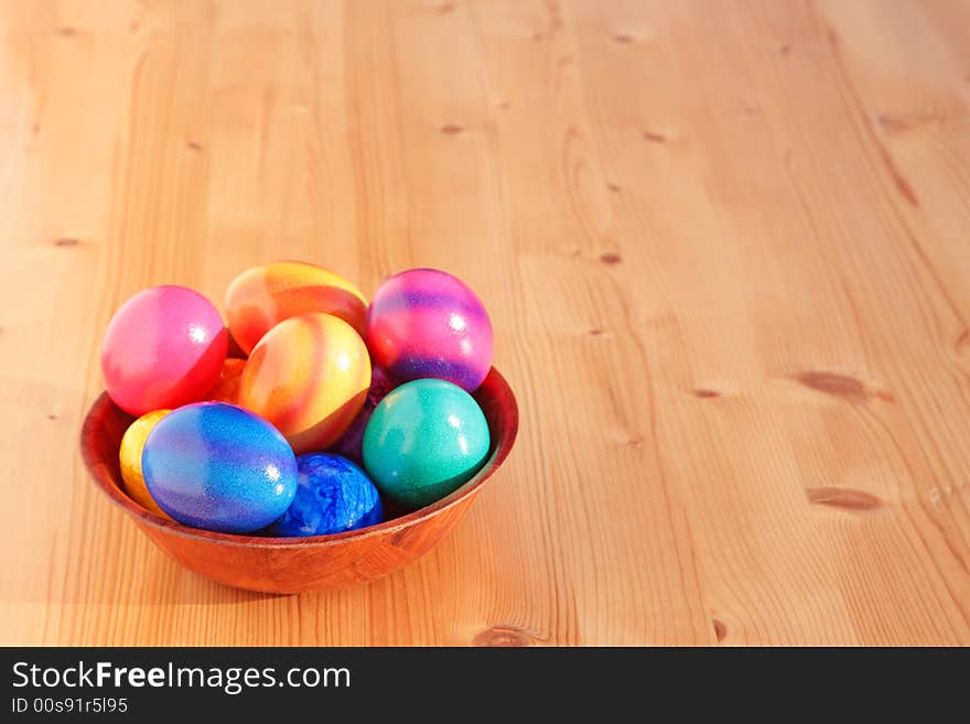 Easter eggs in the cup on a wooden table. Easter eggs in the cup on a wooden table.