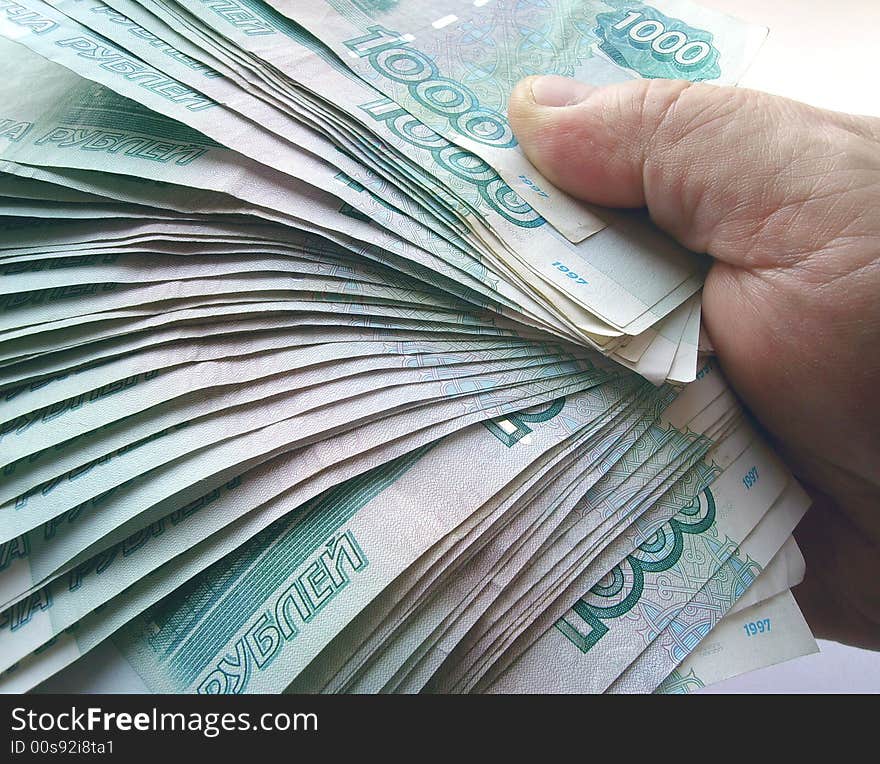 The hands, holding many of the Russian banknotes