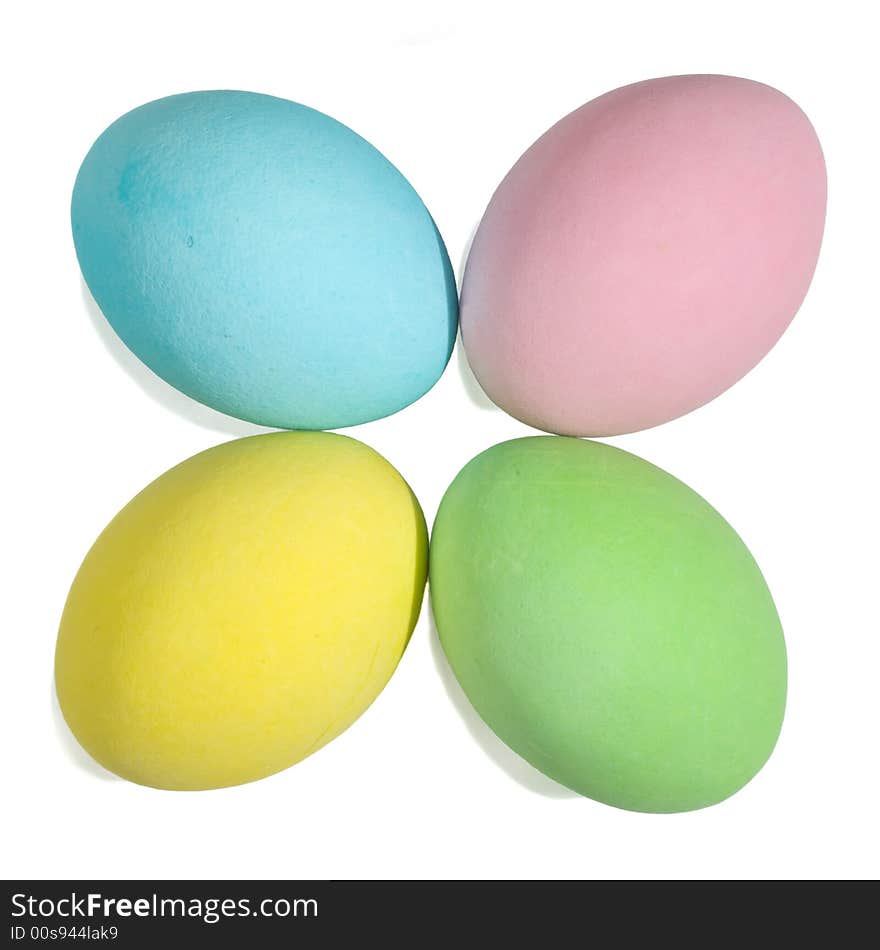 Closeup of a 4 colored easter eggs isolated in white background. Little shadow.