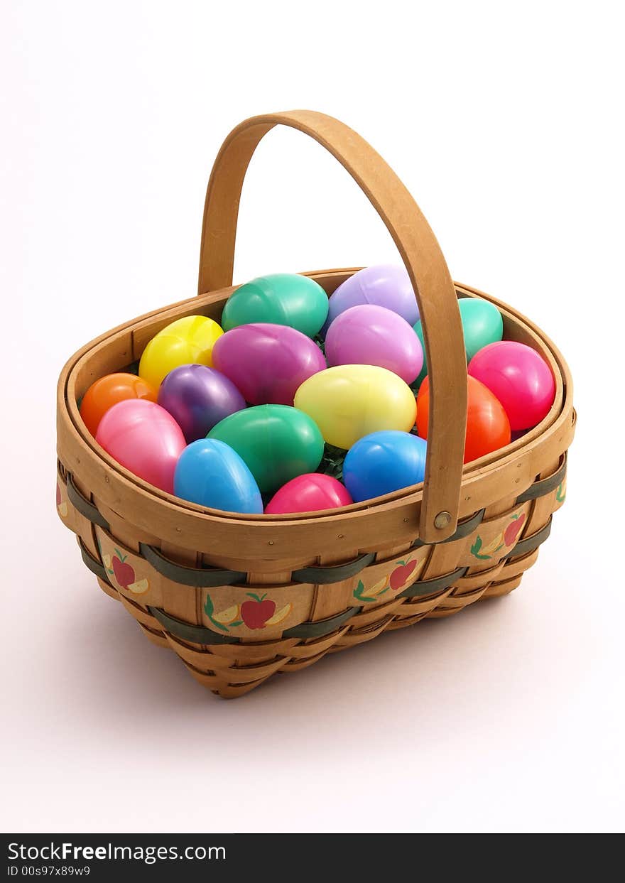 Wicker Easter Basket full of colorful eggs. Wicker Easter Basket full of colorful eggs