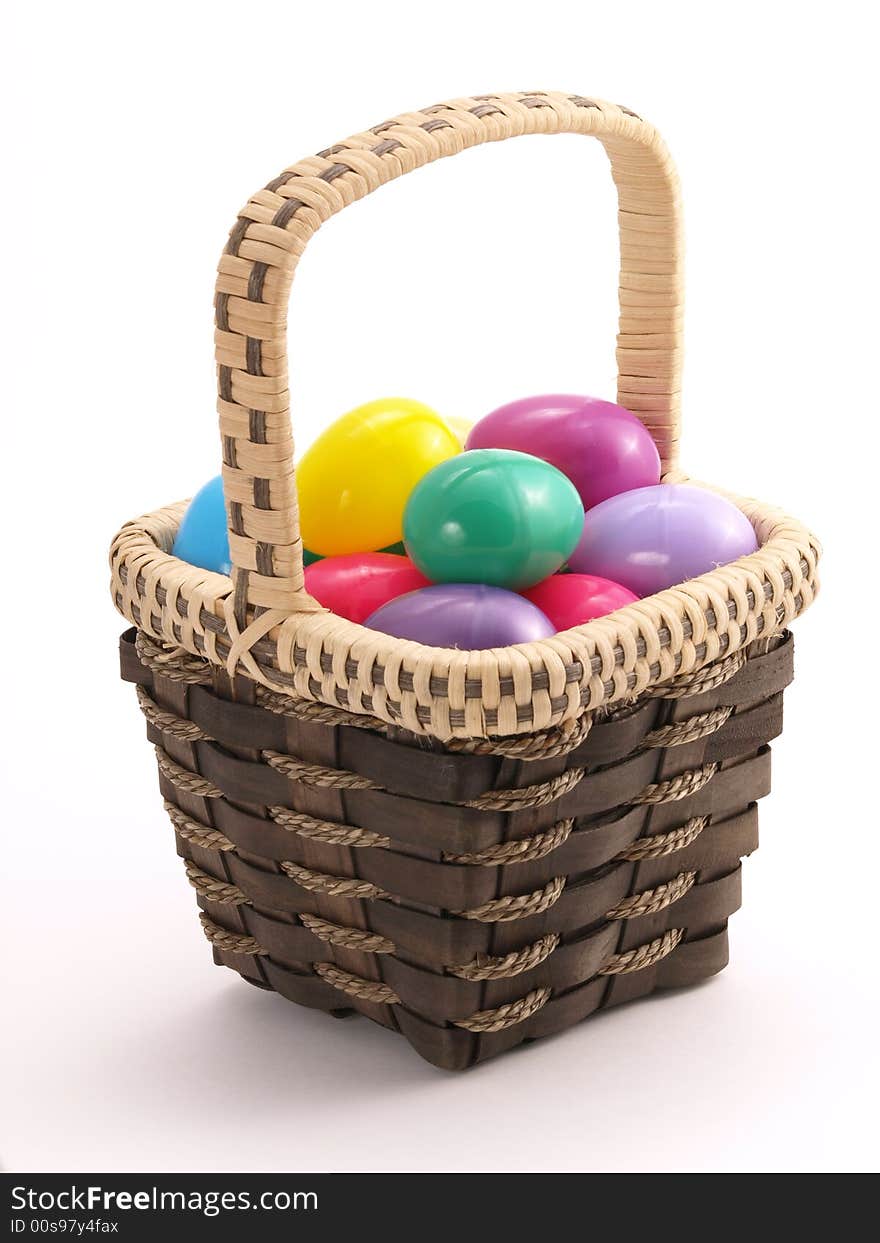 Wicker Easter Basket full of colorful eggs. Wicker Easter Basket full of colorful eggs