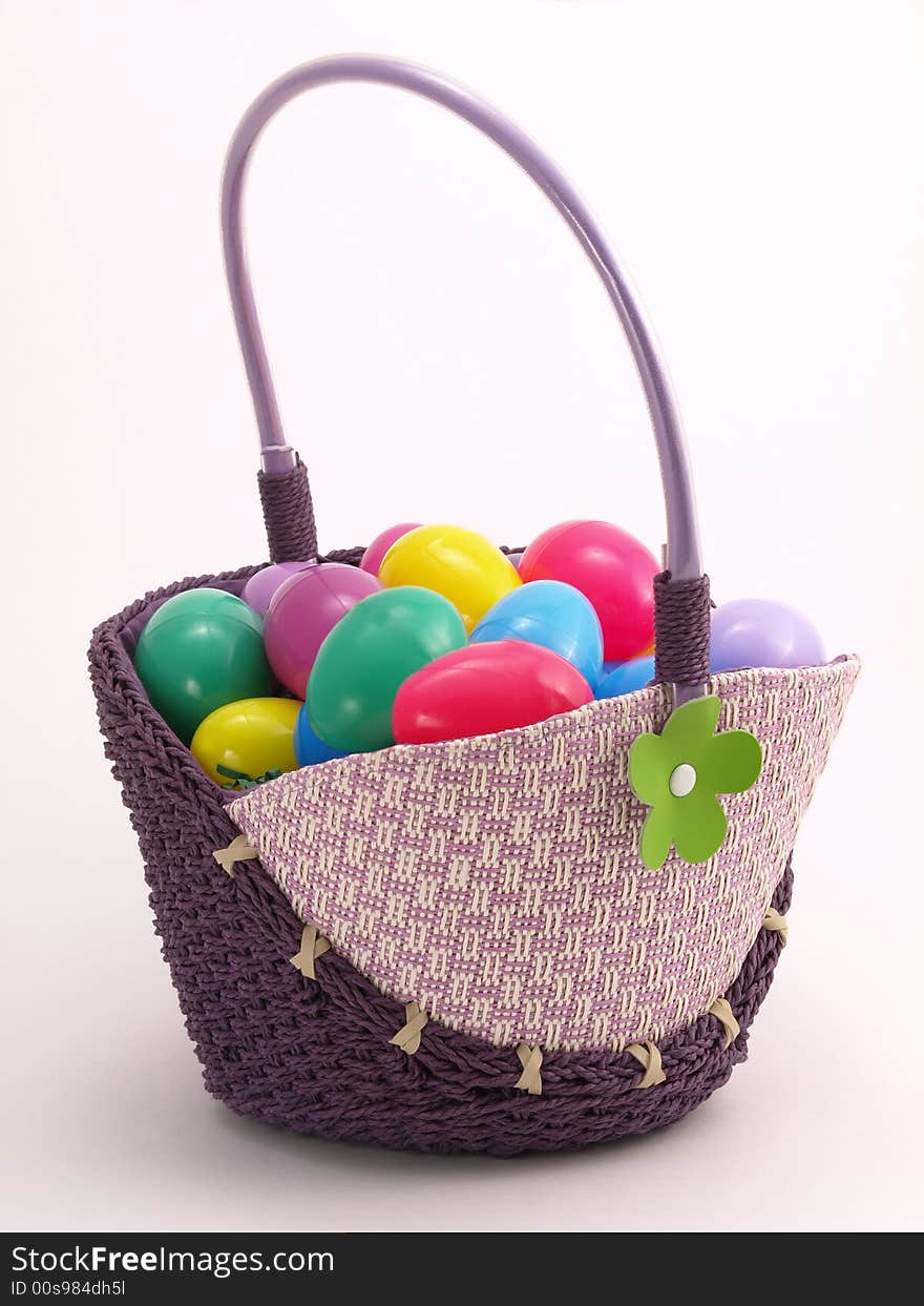 Wicker Easter Basket full of colorful eggs. Wicker Easter Basket full of colorful eggs