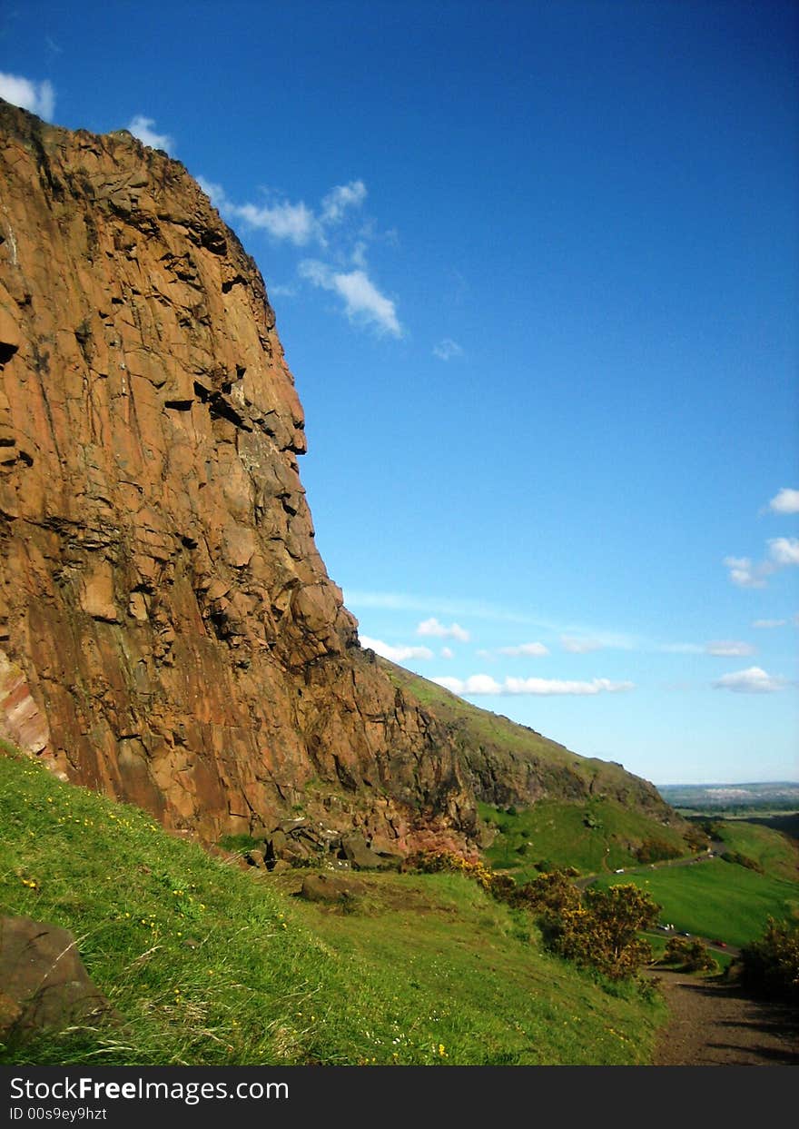 Climbing to the top of Arthur's Seat, Edinburgh, Scotland with horizon in background and room for copy. Climbing to the top of Arthur's Seat, Edinburgh, Scotland with horizon in background and room for copy