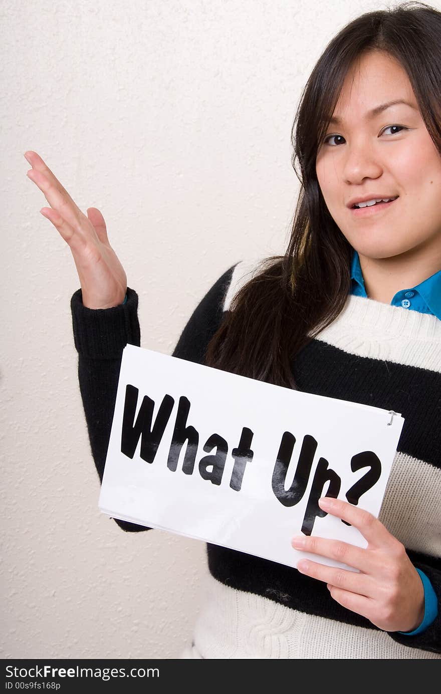 Female holding up a What up? sign with one hand. Female holding up a What up? sign with one hand.