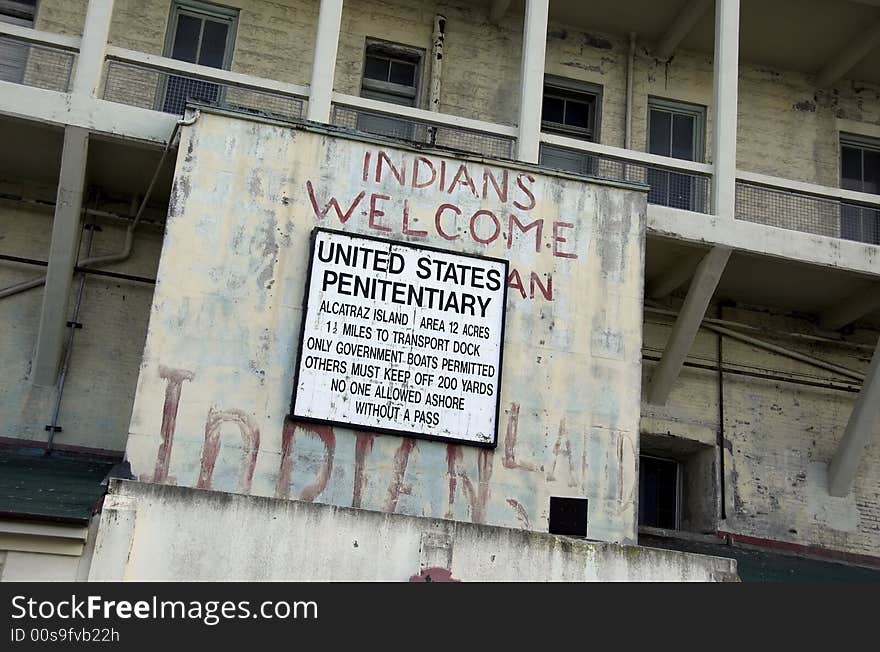 Old and decayed Alcatraz jail sign. Note graffiti painted on walls from the days of occupation by the American Indian Movement in the 1970s. Old and decayed Alcatraz jail sign. Note graffiti painted on walls from the days of occupation by the American Indian Movement in the 1970s.