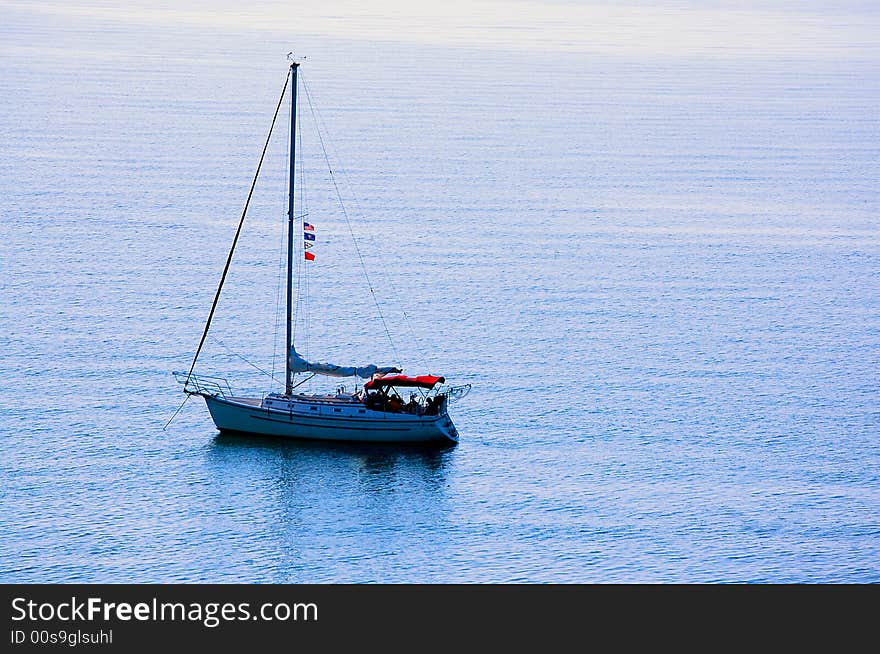 Sailing yacht anchored off lake michigan coast.