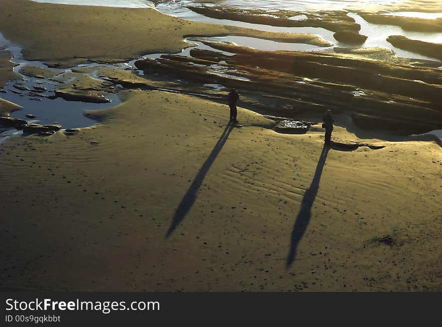 Two men stand on the beach. Two men stand on the beach