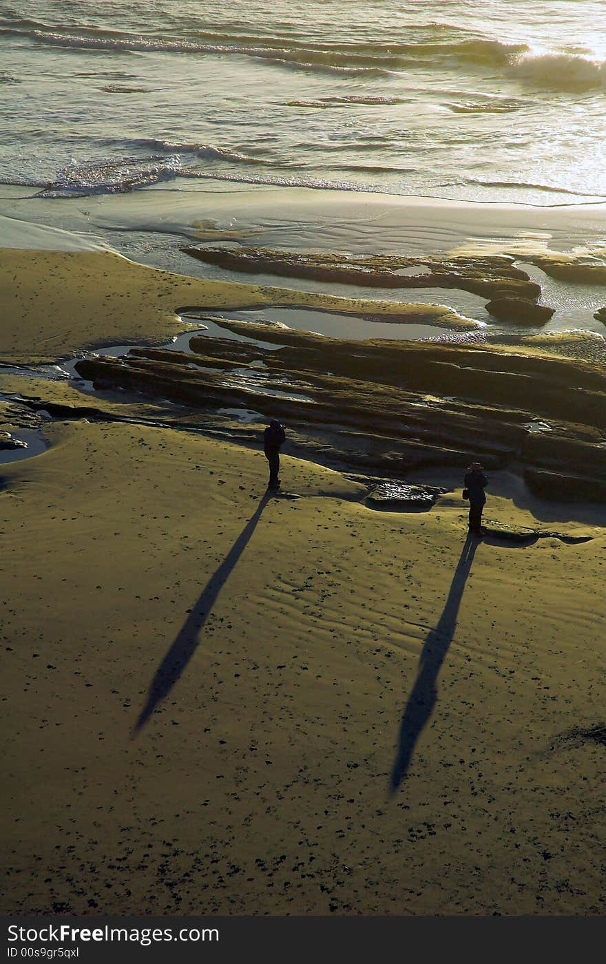 Two Men Stand on a Beach. Two Men Stand on a Beach