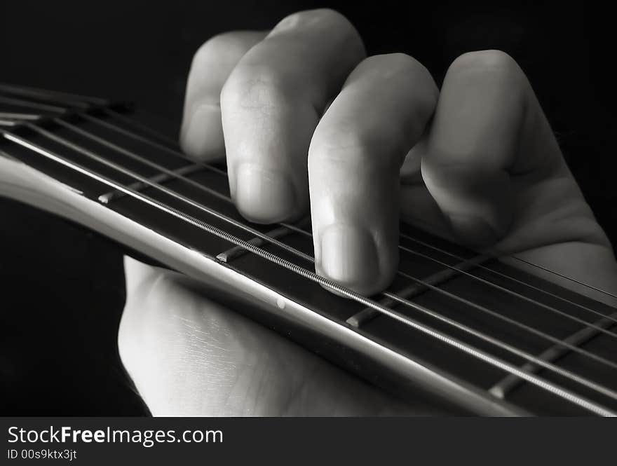 Hand forming chord on guitar. Hand forming chord on guitar